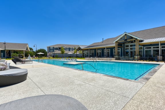 a swimming pool with a building in the background at Estraya Boerne, Boerne