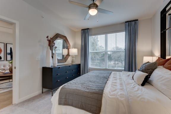 a bedroom with a large bed and a ceiling fan at Estraya Boerne, Texas