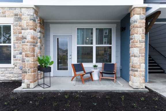 a patio with chairs and a table on a porch at Estraya Boerne, Texas