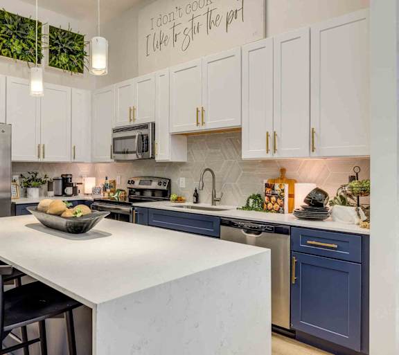 A kitchen with a white countertop and blue cabinets.