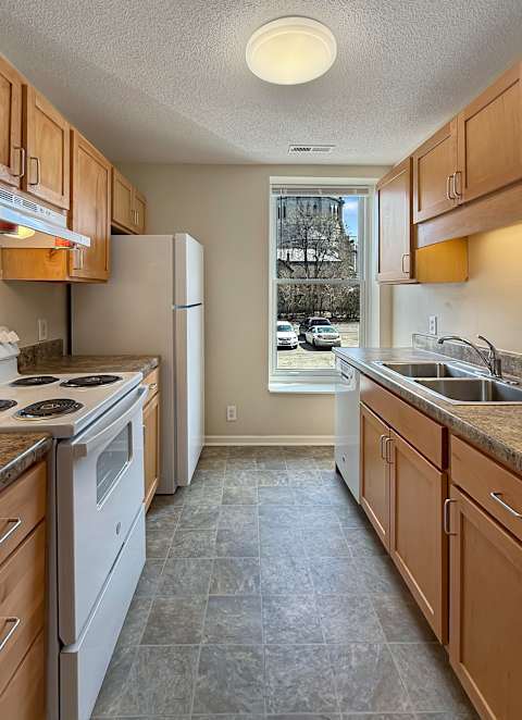 A room with a carpeted floor and a large window.