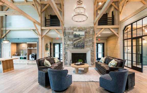 an indoor clubhouse with couches and chairs and a fireplace at Bellary Flats, Summerville, SC 29486