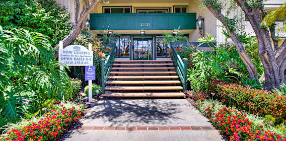 a covered patio with a bar and apartments in the background at Camino de Oro Apartments, California, 90505