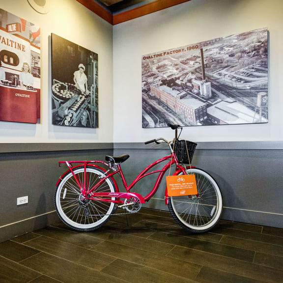 a red bike parked next to a wall in a room