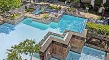 A large swimming pool with a small one in the middle.
