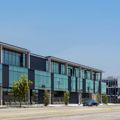 A modern building with large glass windows and a black and white exterior.