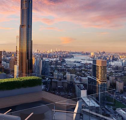 a rooftop terrace with a view of the city and a sunset at The Paxton, Brooklyn, 11201