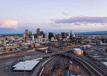 A cityscape with a highway interchange and buildings.