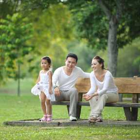 A group of diverse people are huddled together, smiling and enjoying each other's company.