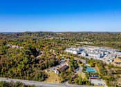 Thumbnail 23 of 28 - A bird's eye view of a residential area with a large building and a swimming pool at Landmark at Lyncrest Reserve Apartments, Nashville, TN