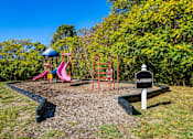 Thumbnail 27 of 28 - a playground with slides and other toys in a park at Landmark at Lyncrest Reserve Apartments, Nashville, TN