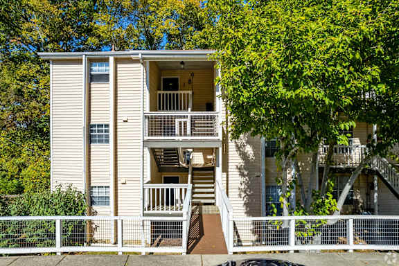 a white apartment building with stairs and trees at Landmark at Lyncrest Reserve Apartments, Nashville, TN