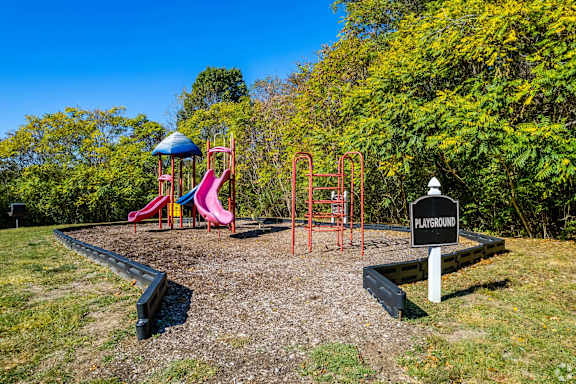 a playground with slides and other toys in a park at Landmark at Lyncrest Reserve Apartments, Nashville, TN