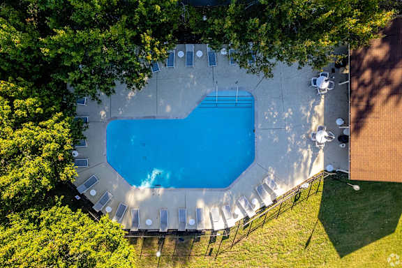An aerial view of a swimming pool surrounded by trees at Landmark at Lyncrest Reserve Apartments, Nashville, TN