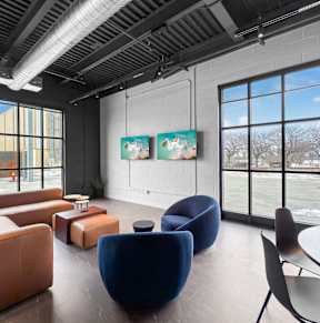 A living room with a brick wall and a fireplace.at Plant 1 Lofts, Iowa