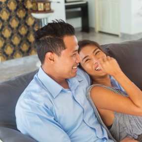 Man and Woman sitting on couch and laughing at White Oak Gardens, Encino, California