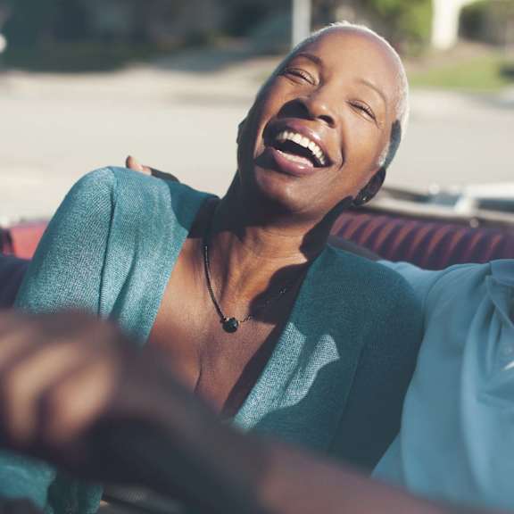 Two people enjoying a car ride at Hadley Apartments, Escondido, CA