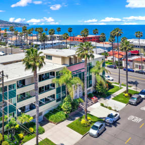 an aerial view of a building with palm trees and the ocean in the background  at Royal Towers Apartments, Redondo Beach, CA, 90277