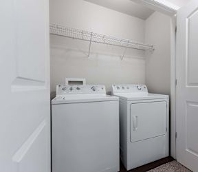 A white laundry room with a washer and dryer. at Danamere Village, Iowa, 50047