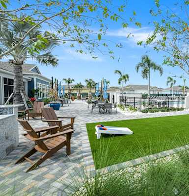a courtyard with a lawn and tables and chairs
