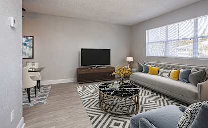 our apartments offer a living room with a couch and a tv