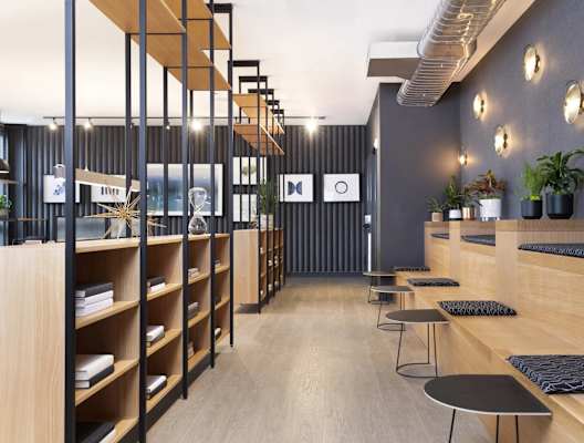 A modern interior with wooden shelves and black and white decor.