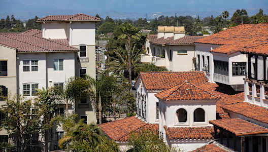A row of houses with red tile roofs.