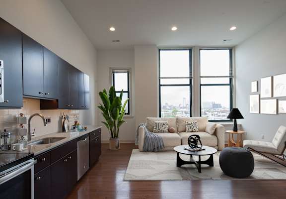 A modern kitchen with dark wood cabinets and a large island.