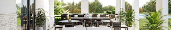 A modern outdoor seating area at Stillwater Lakes Apartments, Kissimmee, FL 34744