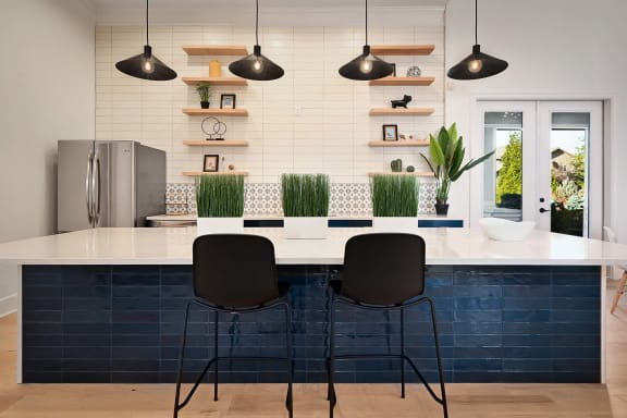 a kitchen with a white counter top and blue tiles at Sovereign at Overland Park, Kansas, 66213