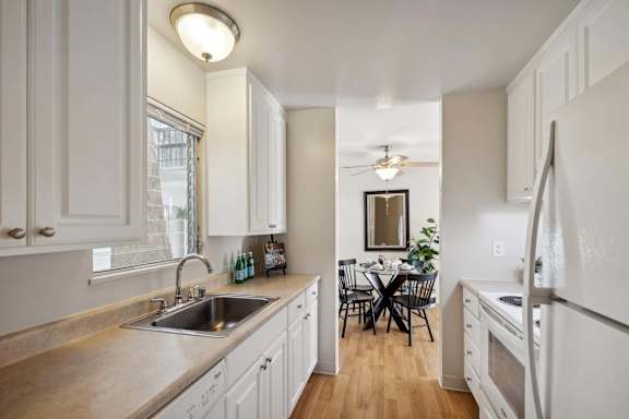 A kitchen with a table and chairs in the middle of the room.