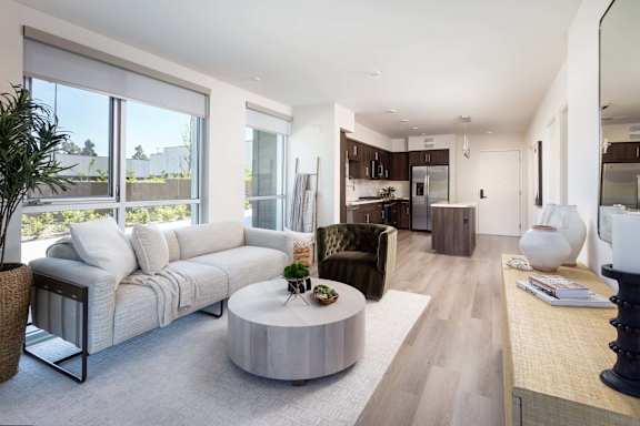 Bright living room with open floor plan and large windows at Elements Apartments, Irvine, CA 92612