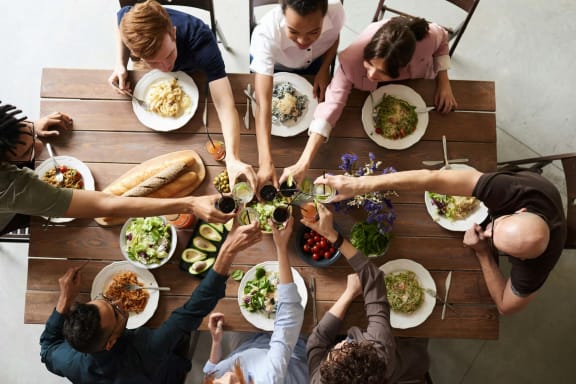 a group of people sitting around a table eating food