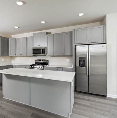 a kitchen with stainless steel appliances and white counter tops