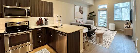 A modern kitchen with stainless steel appliances and wooden cabinets.