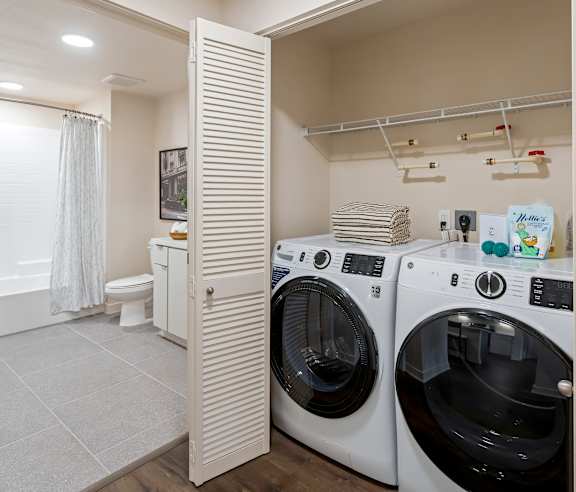 A laundry room with a washer and dryer. at Casa Mira View Apartments, San Diego, CA 92126