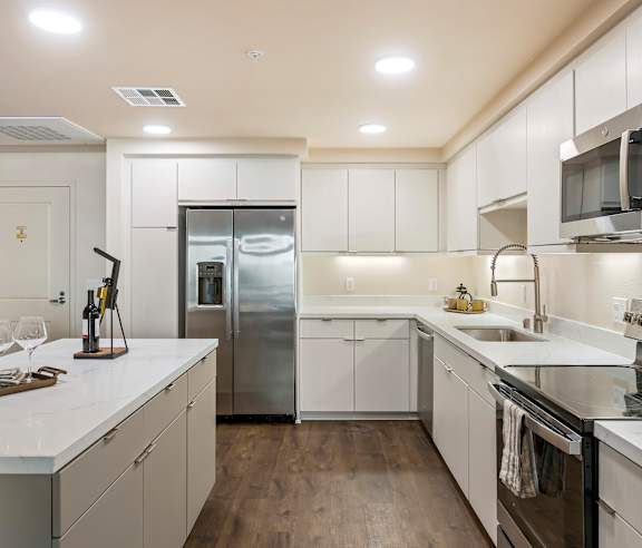 A modern kitchen with white cabinets and stainless steel appliances. at Casa Mira View Apartments, San Diego, CA 92126