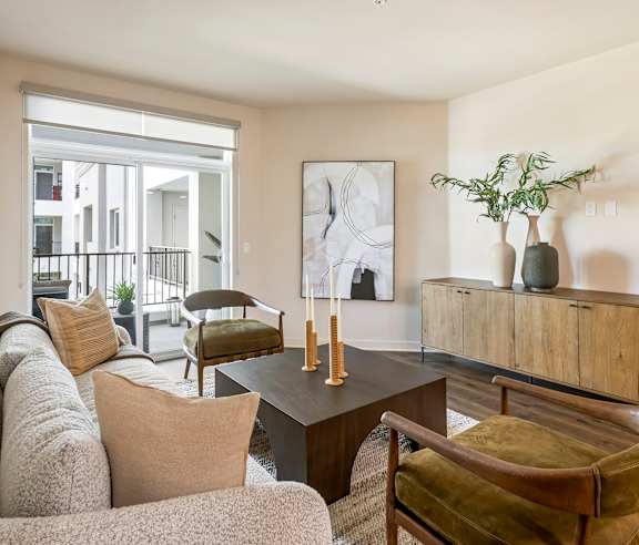 A living room with a couch, chair, and a table with a vase on it. at Casa Mira View Apartments, San Diego, CA 92126
