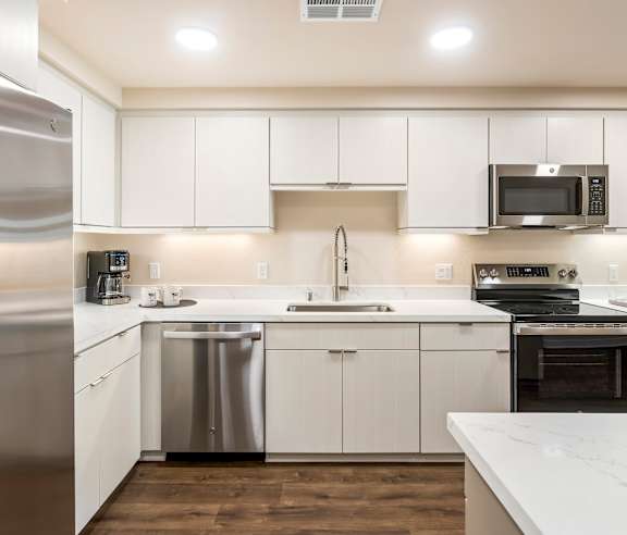 A modern kitchen with white cabinets and stainless steel appliances. at Casa Mira View Apartments, San Diego, CA 92126