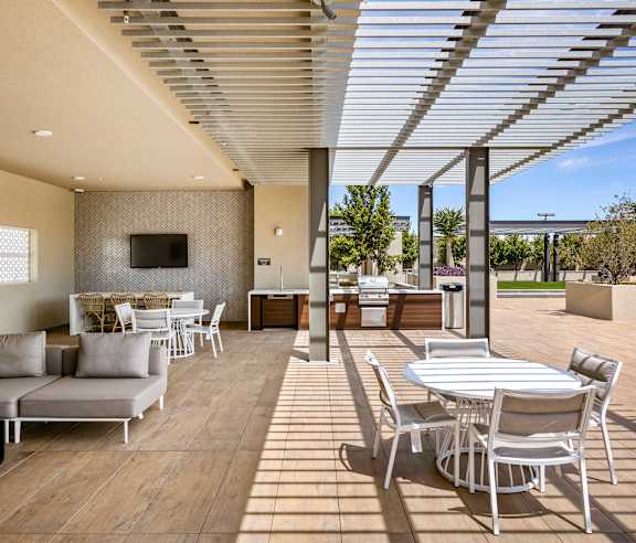 A patio with a white table and chairs. at Casa Mira View Apartments, San Diego, CA 92126