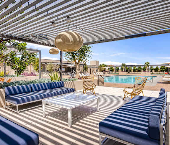 A patio with a pool and sun loungers. at Casa Mira View Apartments, San Diego, CA 92126