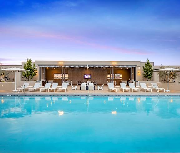 A pool in front of a building with a stage and chairs. at Casa Mira View Apartments, San Diego, CA 92126