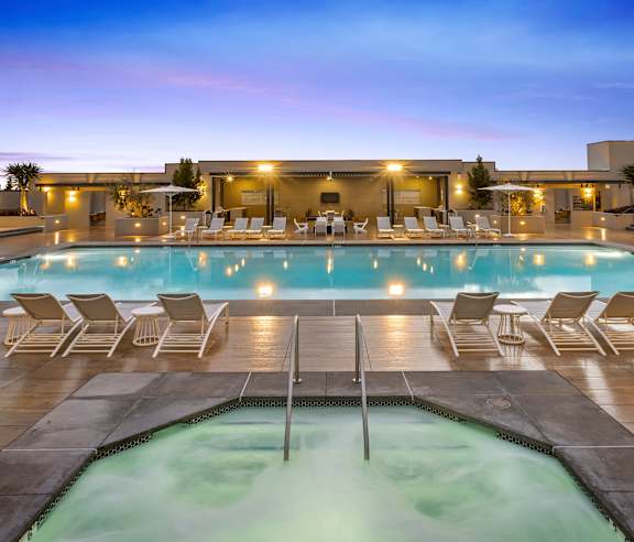 A pool with a hot tub and lounge chairs. at Casa Mira View Apartments, San Diego, CA 92126