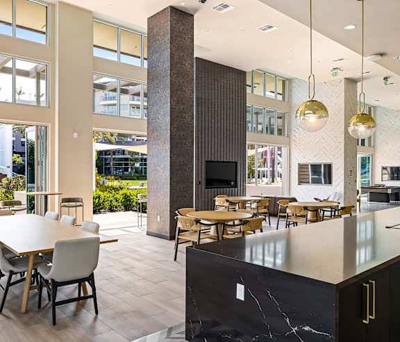 A large room with a long table and chairs. at Elements Apartments, Irvine, CA