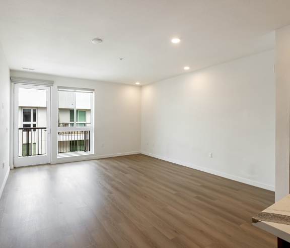 A large empty room with wooden floors and white walls. at Elements Apartments, Irvine, CA