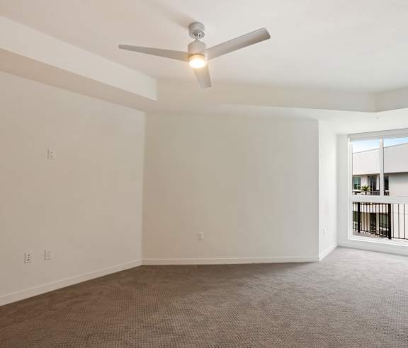 A room with a ceiling fan and carpeted floor. at Elements Apartments, Irvine, CA