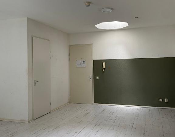 a bedroom with a bed and a desk and a window