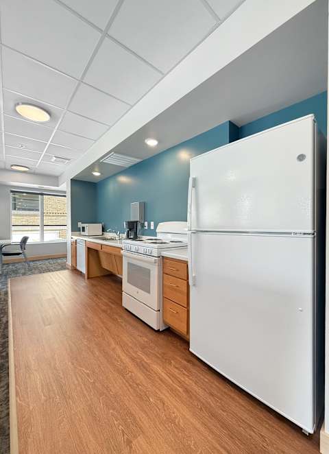 A kitchen with wooden cabinets and white appliances.