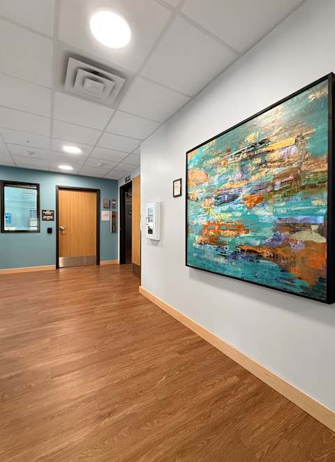 A room with a carpeted floor and a large window.