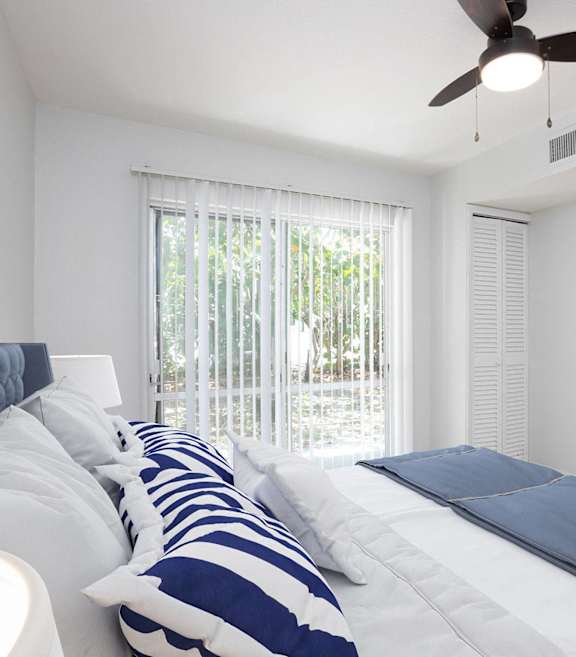 a bedroom with a large bed and a ceiling fan